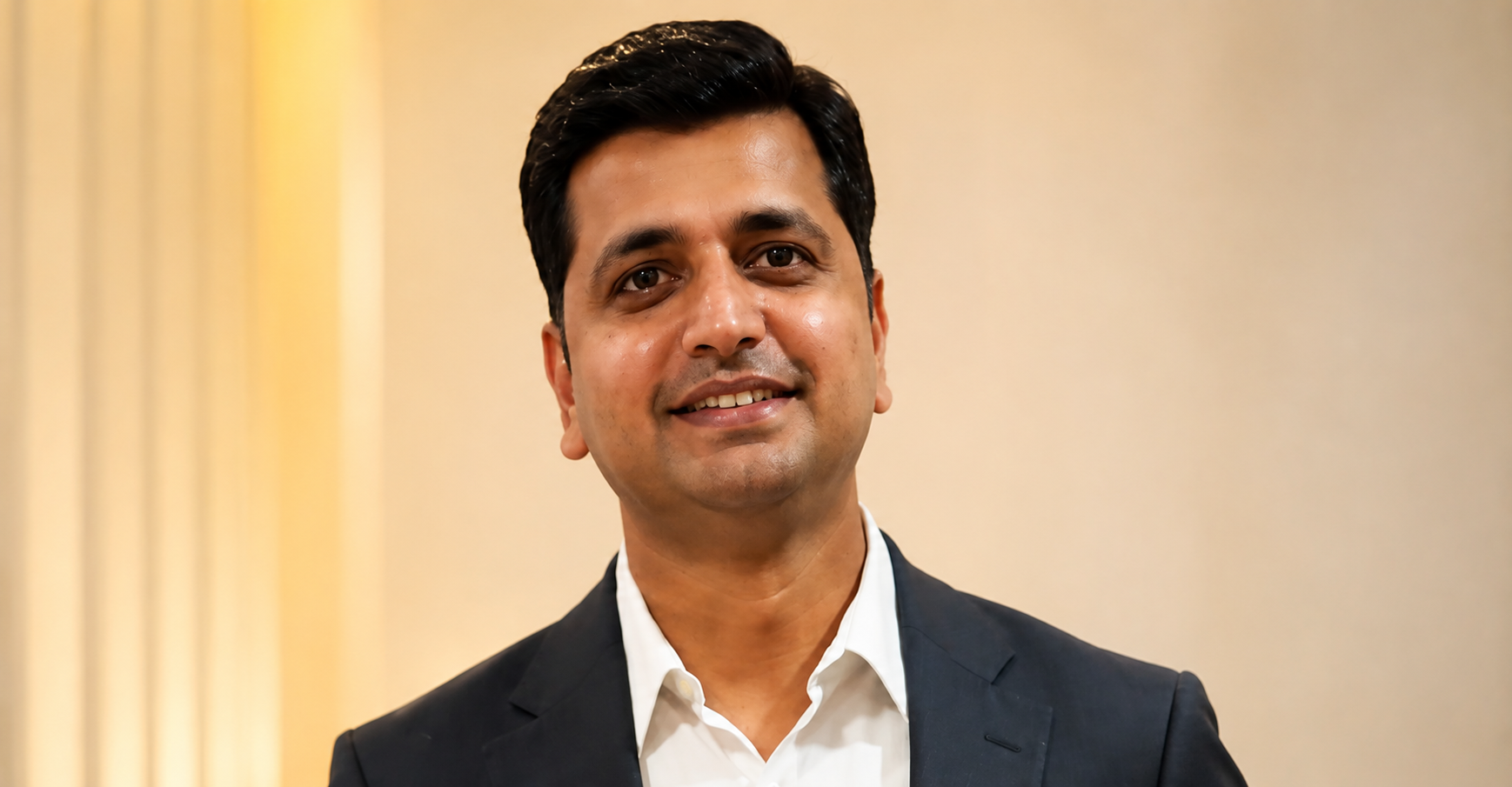 A confident businessman in a suit standing outside modern architecture