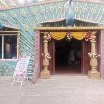 The entrance dressed with floral garlands and drapes for a wedding